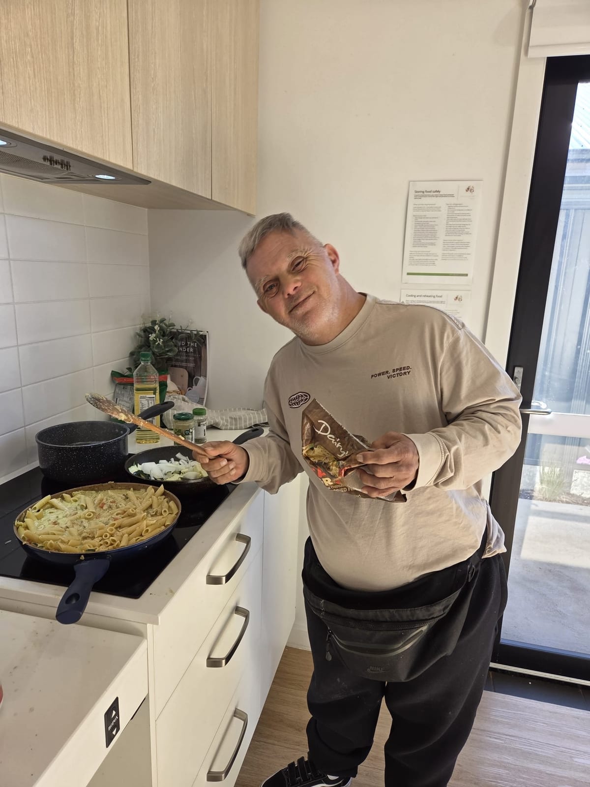 A QB Care participant cooking at home
