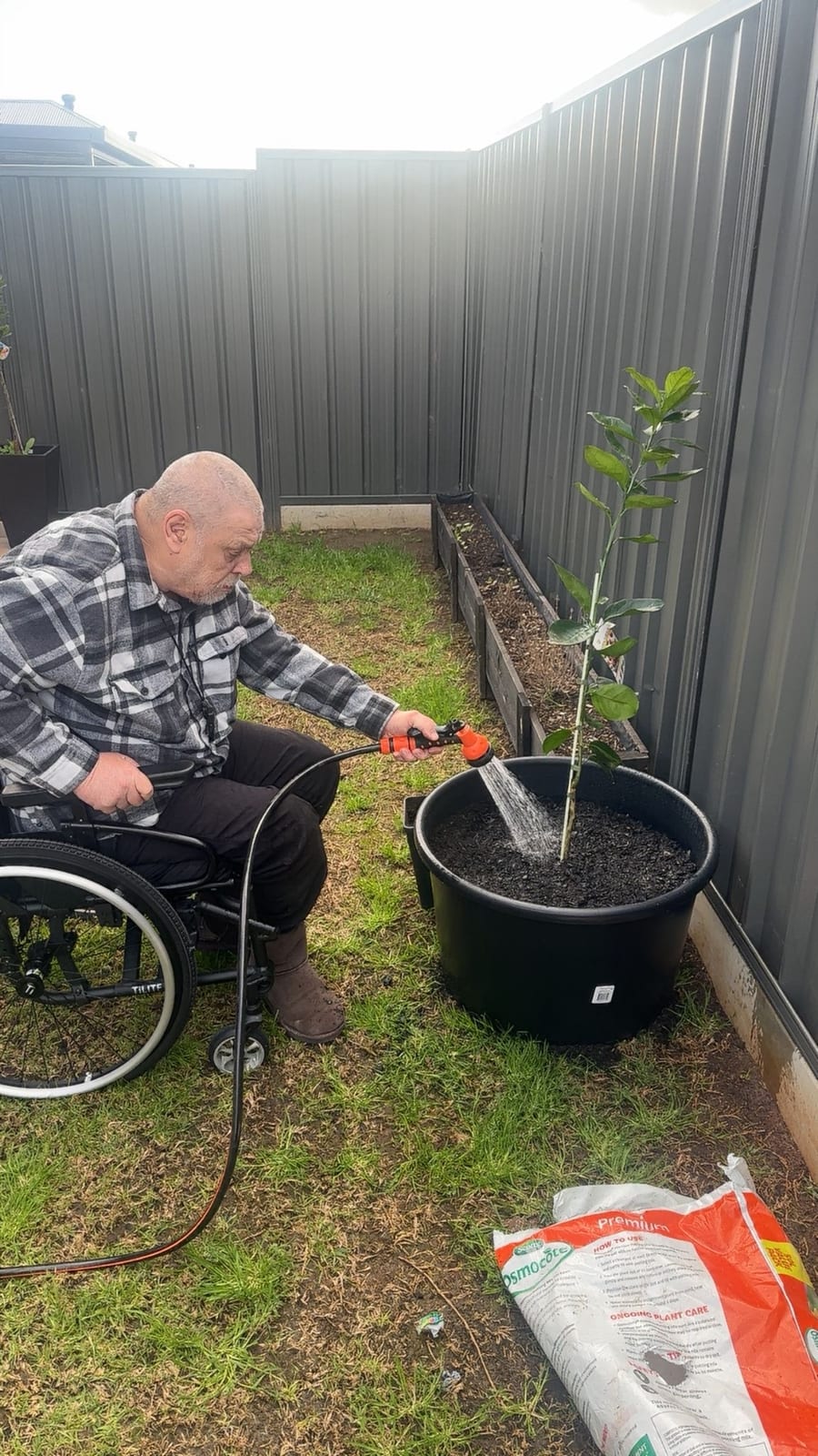 A QB Care participant gardening at home